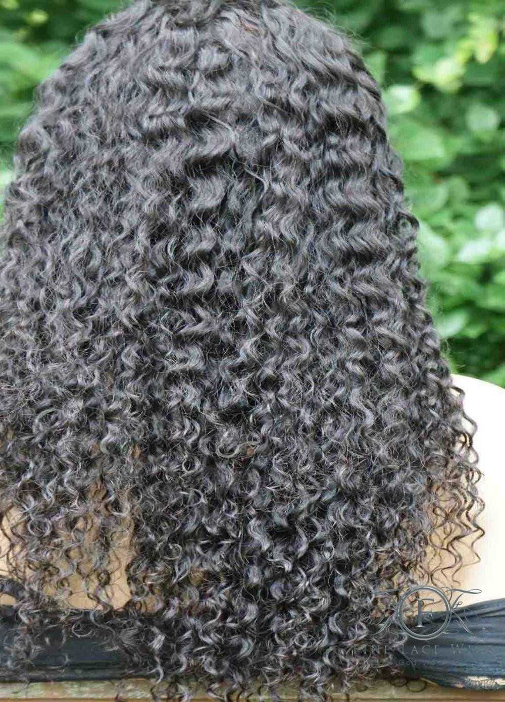 Curly human hair wig made from natural human hair.  This curly-long wig has a pre-plucked hairline, HD lace, and clean bleached 