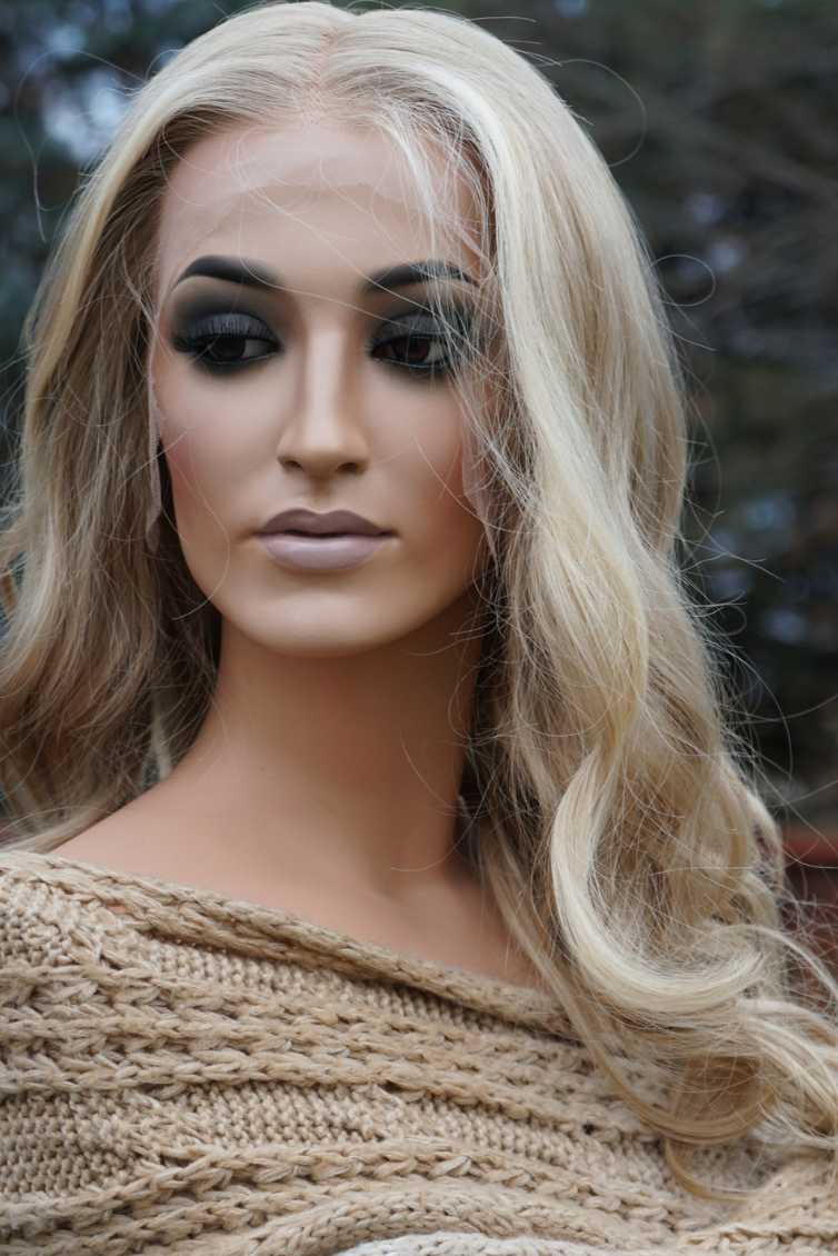 Shoulder-length buttermilk blonde tousled wavy wig, high-quality human hair, lace top construction, natural hairline.
